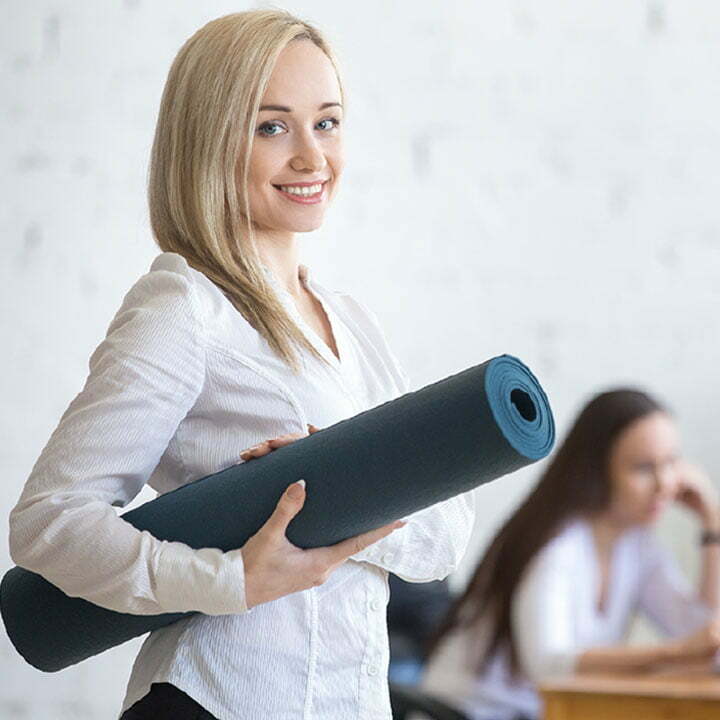 Woman holding a yoga mat